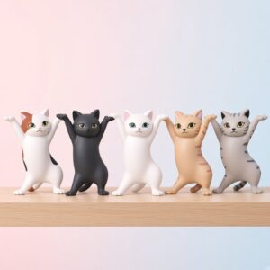 Five dancing cat figurines in white, black, calico, tan and grey tabby lined up in a row